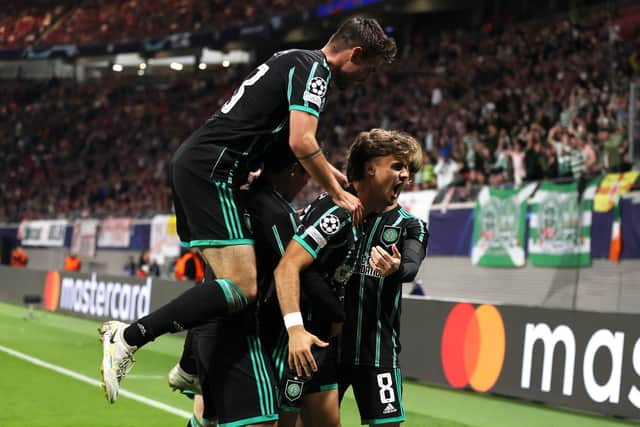 Jota of Celtic celebrates with teammates after scoring their team's first goal