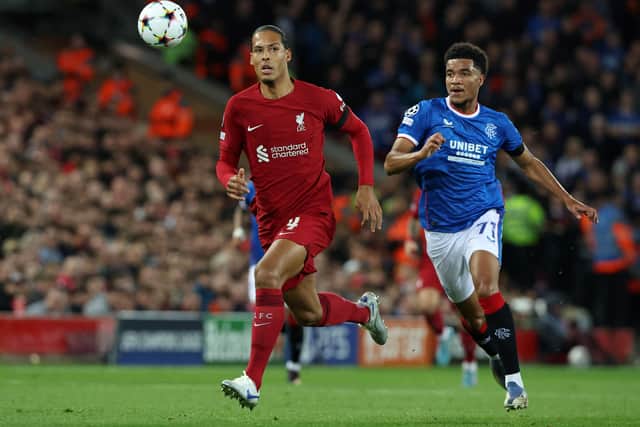 Liverpool’s Dutch defender Virgil van Dijk (L) chases after the ball followed by Rangers’ German-born US midfielder Malik Tillman