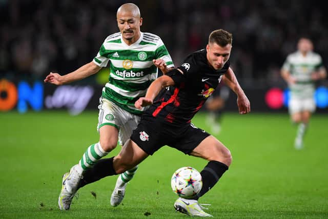 Celtic's Japanese striker Daizen Maeda (L) vies with RB Leipzig's Hungarian defender Willi Orban 