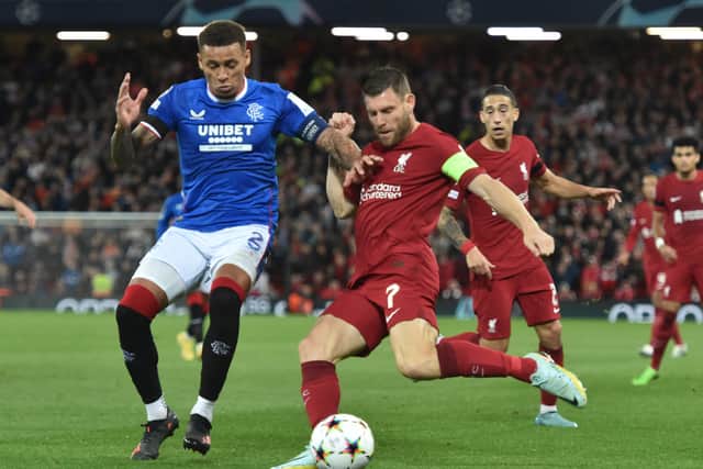James Milner of Liverpool and James Tavernier of Rangers during the UEFA Champions League group A match at Anfield