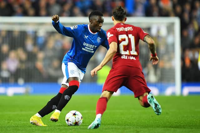 Rangers' Zambian striker Fashion Sakala (L) vies with Liverpool's Greek defender Kostas Tsimikas (R)