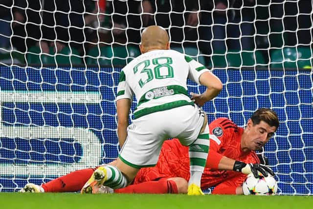 Real Madrid's Belgian goalkeeper Thibaut Courtois (rear) stop a ball shot by Celtic's Japanese striker Daizen Maeda