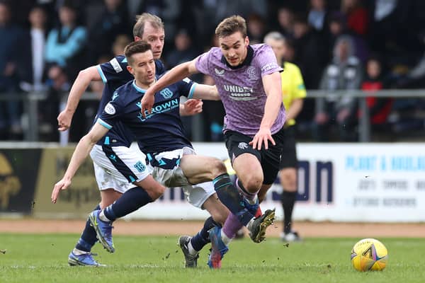 James Sands is challenged by Cammy Kerr during the Scottish Cup Sixth Round match between Dundee FC and Rangers FC at Dens Park Stadium in March 2022