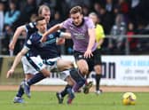 James Sands is challenged by Cammy Kerr during the Scottish Cup Sixth Round match between Dundee FC and Rangers FC at Dens Park Stadium in March 2022