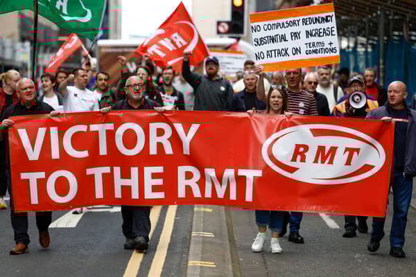 RMT supporters march from the offices of Network Rail following the industrial action last March 