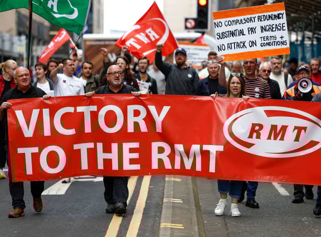 RMT supporters march from the offices of Network Rail following the industrial action last March 