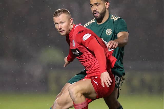 Curtis Main of St Mirren is challenged by Cameron Carter-Vickers of Celtic during the Cinch Scottish Premiership match