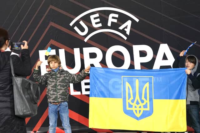 Young Dynamo Kiev fans pose with a Ukrainian flag prior to the UEFA Europa League Group B football match between Dynamo Kyiv and Stade Rennais FC in Krakow, Poland