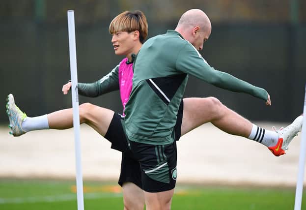 Celtic’s Japanese striker Kyogo Furuhashi (L) and Australian midfielder Aaron Mooy attend a team training session