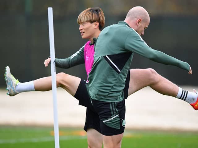Celtic’s Japanese striker Kyogo Furuhashi (L) and Australian midfielder Aaron Mooy attend a team training session