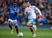 Rangers’ Welsh midfielder Rabbi Matondo (L) and Napoli’s Georgian forward Khvicha Kvaratskhelia vie for the ball during the UEFA Champions League Group A football match at Ibrox
