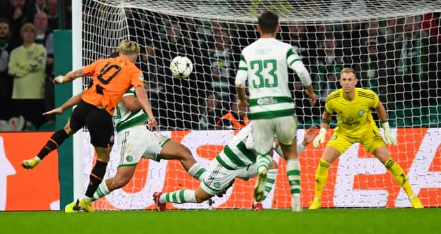 Shakhtar Donetsk's Ukranian forward Mykhaylo Mudryk (L) shoots and scores his team first goal