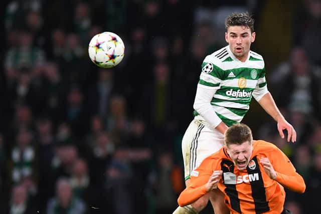 Celtic's English midfielder Matt O'Riley (L) fights for the ball with Shakhtar Donetsk's Ukranian midfielder Artem Bondarenko
