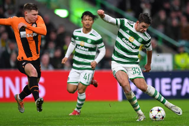 Celtic’s English midfielder Matt O’Riley (R) shoots under pressure from a Shakhtar Donetsk defender