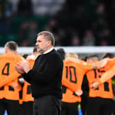 Celtic’s Greek Australian head coach Ange Postecoglou (C) applauds supporters in front of Shakhtar Donetsk’s teammates at the end of the UEFA Champions League Group F match