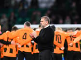 Celtic’s Greek Australian head coach Ange Postecoglou (C) applauds supporters in front of Shakhtar Donetsk’s teammates at the end of the UEFA Champions League Group F match