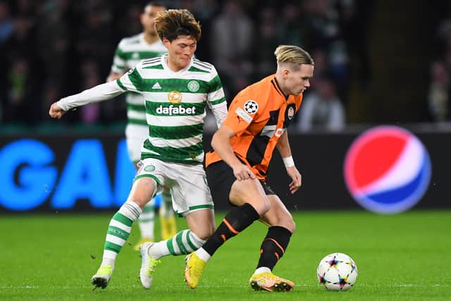 Celtic's Japanese striker Kyogo Furuhashi (L) fights for the ball with Shakhtar Donetsk's Ukranian forward Mykhaylo Mudryk
