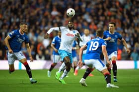 Napoli's Cameroonian midfielder Andre Zambo Anguissa (C) attemps to control the ball as Rangers' Scottish midfielder Ryan Jack (R), Rangers' US midfielder James Sands (2nd R) and Rangers' Croatian defender Borna Barisic (L) eye the ball