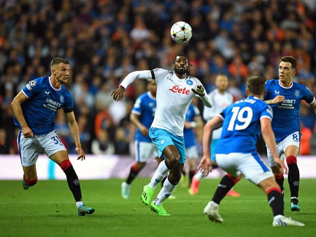 Napoli's Cameroonian midfielder Andre Zambo Anguissa (C) attemps to control the ball as Rangers' Scottish midfielder Ryan Jack (R), Rangers' US midfielder James Sands (2nd R) and Rangers' Croatian defender Borna Barisic (L) eye the ball