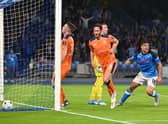 Napoli’s Argentinian forward Giovanni Simeone (R) reacts as he scores a goal  during the UEFA Champions League Group A second leg match against Rangers at the Diego Armando Maradona Stadium in Naples