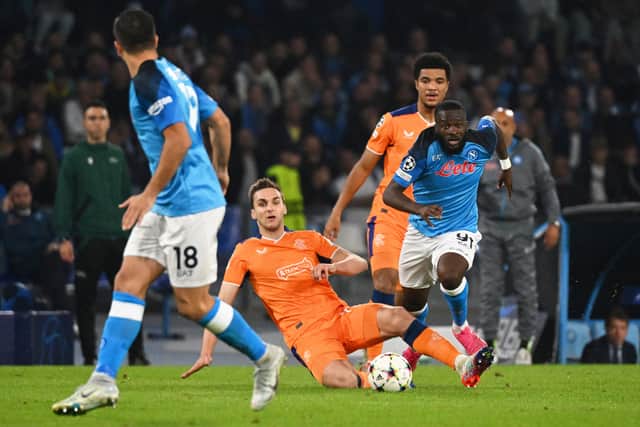 Rangers' US midfielder James Sands (C) fights for the ball with Napoli's French midfielder Tanguy NDombele (R)