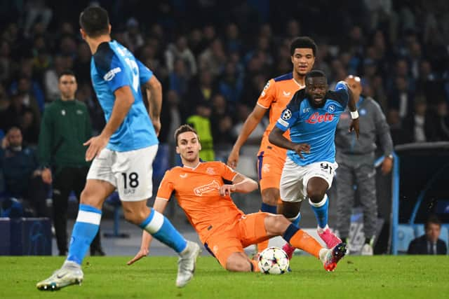 Rangers' US midfielder James Sands (C) fights for the ball with Napoli's French midfielder Tanguy NDombele (R) 