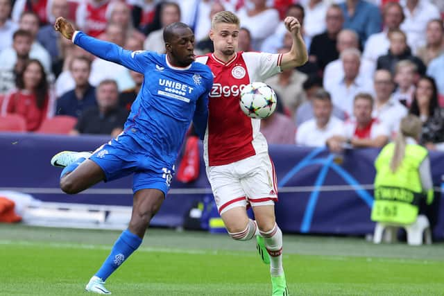 Rangers Finnish midfielder Glen Kamara (L) fights for the ball with Ajax’s Dutch midfielder Kenneth Taylor 