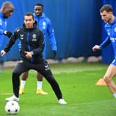 Rangers' Finnish midfielder Glen Kamara (L) and Rangers' Dutch manager Giovanni van Bronckhorst (C) take part in a team training session 