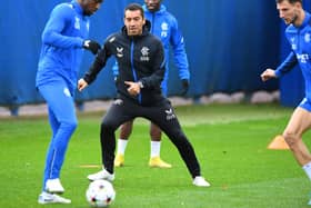 Rangers' Finnish midfielder Glen Kamara (L) and Rangers' Dutch manager Giovanni van Bronckhorst (C) take part in a team training session 