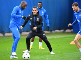 Rangers' Finnish midfielder Glen Kamara (L) and Rangers' Dutch manager Giovanni van Bronckhorst (C) take part in a team training session 