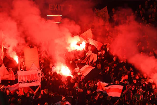 Ajax fans let of flares during the UEFA Champions League Group A match at Ibrox