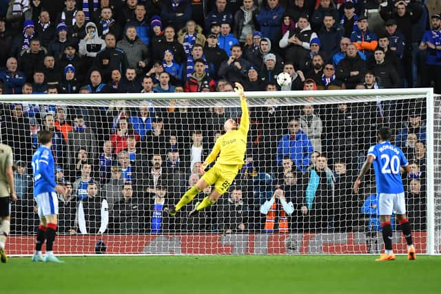 Ajax’s Dutch goalkeeper Remko Pasveer tips Scott Arfield’s shot over the crossbar 