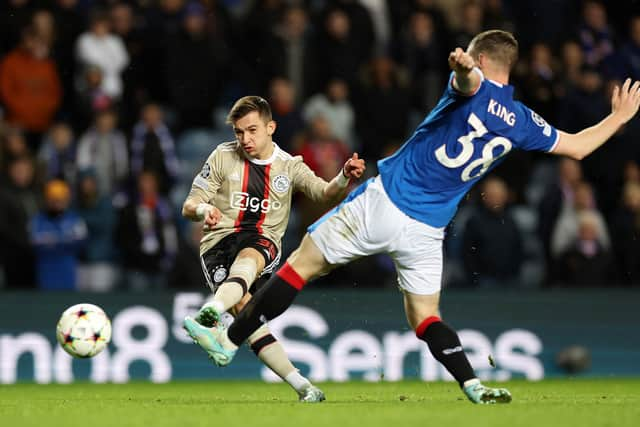 Francisco Conceicao of AFC Ajax scores their side's third goal whilst under pressure from Leon King of Rangers 