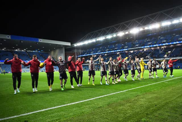 Ajax players celebrate after the final whistle as they sealed a third place finish and European football in the new year