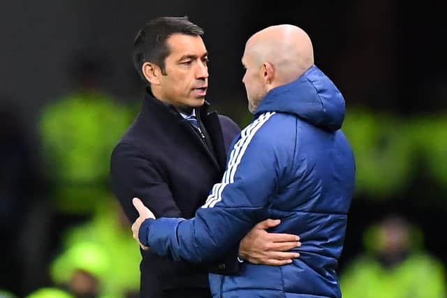 Rangers’ Dutch manager Giovanni van Bronckhorst (L) speaks to Ajax’s Dutch head coach Alfred Schreuder (R) at full-time