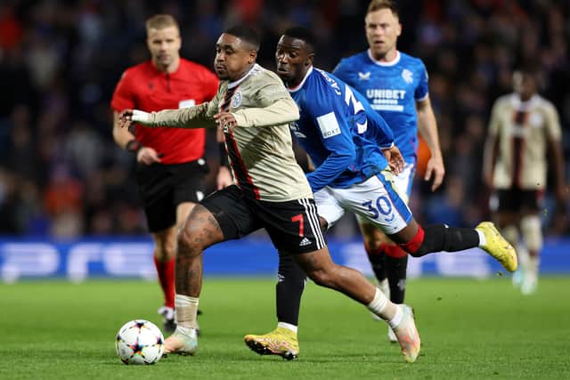 Steven Bergwijn of AFC Ajax runs with the ball whilst under pressure from Fashion Sakala of Rangers