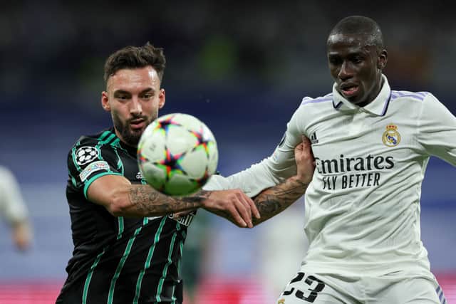 Celtic's Montenegro striker Sead Haksabanovic (L) fights for the ball with Real Madrid's French defender Ferland Mendy