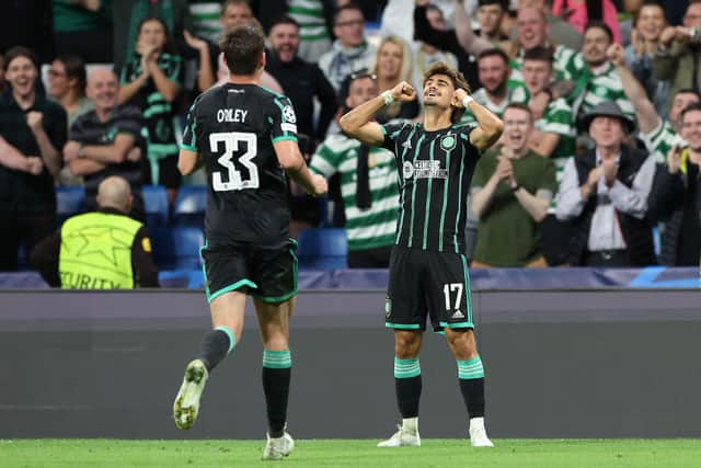 Celtic's Portuguese midfielder Joao Pedro Neves Filipe (R) celebrates after scoring his team's first goal 