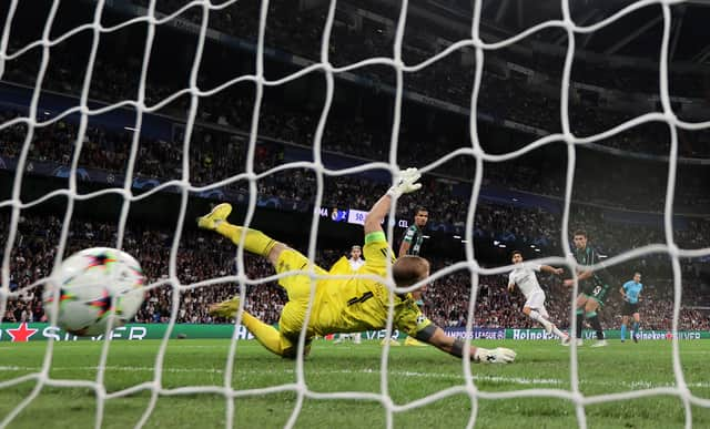 Marco Asensio of Real Madrid scores their sides third goal past Joe Hart of Celtic