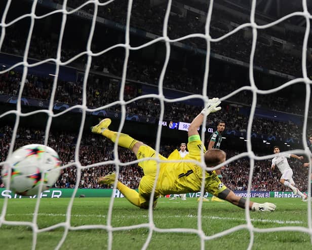 Marco Asensio of Real Madrid scores their sides third goal past Joe Hart of Celtic