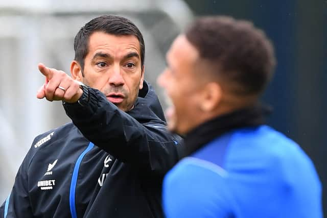 Rangers' Dutch manager Giovanni van Bronckhorst (L) gestures to Rangers' English defender James Tavernier during a team training session