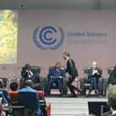 Prime Minister Rishi Sunak is seen running off the stage at an event at COP27 in Egypt.