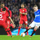 Rangers' Northern Irish midfielder Steven Davis (R) drives the ball during the UEFA Europa League round of 16 first leg football match between Rangers FC and Bayer 04 Leverkusen at the Ibrox Stadium in Glasgow on March 12, 2020. 