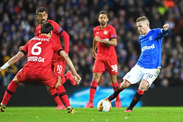 Rangers' Northern Irish midfielder Steven Davis (R) drives the ball during the UEFA Europa League round of 16 first leg football match between Rangers FC and Bayer 04 Leverkusen at the Ibrox Stadium in Glasgow on March 12, 2020. 