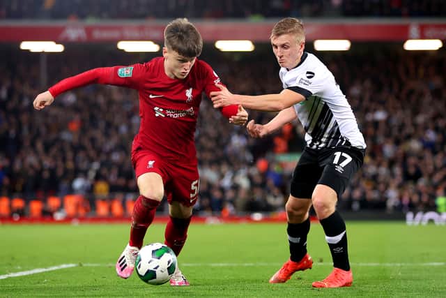 Ben Doak of Liverpool is challenged by Louie Sibley of Derby County during the Carabao Cup Third Round match at Anfield