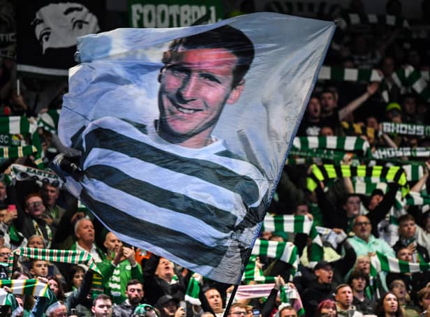 <p>Celtic's fans wave a flag picturing former captain Billy McNeill </p>