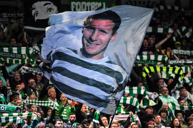 <p>Celtic's fans wave a flag picturing former captain Billy McNeill </p>