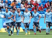 atrick Wood celebrates with team mates after scoring a goal during the round three A-League Men’s match between Sydney FC and Adelaide United at Allianz Stadium