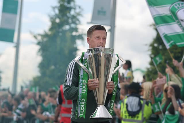 Celtic's captain Callum McGregor arrives with the SPFL trophy 