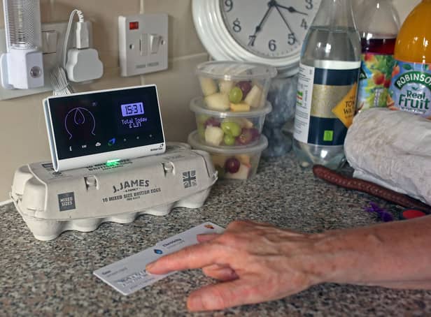 Pensioner Diane Skidmore examines her smart meter in London. 